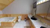 Ensuite bathroom in the master bedroom with tub, double sink vanity, toilet, and standing shower.