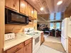Another view of the full galley kitchen. Electric range and microwave.