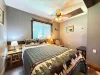 The second cozy bedroom features a comfortable log-framed Queen bed styled with a charming wilderness-themed quilt.
