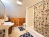Upstairs bathroom with shower, toilet, and sink.