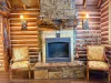 Enjoy the cozy ambiance of the open living room, featuring comfortable seating and a beautiful propane gas fireplace.
