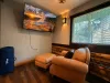 Kick back in the plush leather armchair and ottoman to enjoy movie night on the large wall-mounted Smart TV, complete with a private, cozy viewing angle.