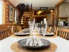 Host memorable family dinners at the large rustic dining table, perfectly set with beautiful tableware right next to the log staircase.