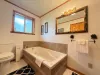 Bathroom is equipped with soaking tub, standing shower, toilet, and sink.