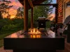 Experience unforgettable evenings on the covered deck, where you can watch a breathtaking golden sunset over the trees while staying cozy by the warm propane gas fire pit table.