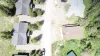 The overhead drone view showcases the cabin's excellent positioning with easy road access, while maintaining a private and relaxing mountain retreat feel.