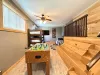 This expansive entertainment loft uniquely combines sleeping options with endless fun, featuring stadium-style wooden bench seating.